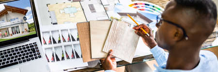 Side View Of Real Estate Designer Working On Computer In Officeの写真素材