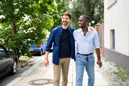 Gay Couple Dating In Jeans. Walking On Street In Cityの写真素材