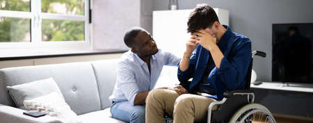 Unhappy Disabled Sad Man In Wheelchair Supportの写真素材