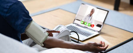 African American With Blood Pressure Or Hypertension Using Telemedicineの写真素材
