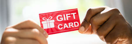 Shopping Gift Card Or Voucher. Hand Giving Incentive