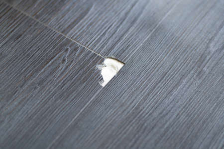 Damaged Wooden Floor. Laminate Scratch. Broken Vinyl Flooringの写真素材
