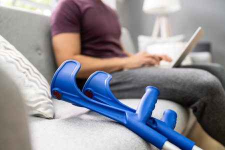 Leg Injured Man With Crutches After Accident