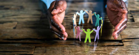 Inclusion, Diversity And Equality. African Hands Safeguard Paper Shapes