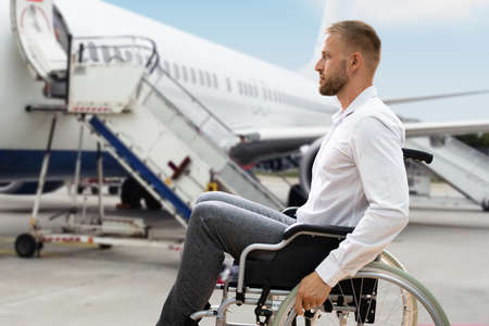 Disabled Adult People Travel In Wheelchair At Airportの写真素材