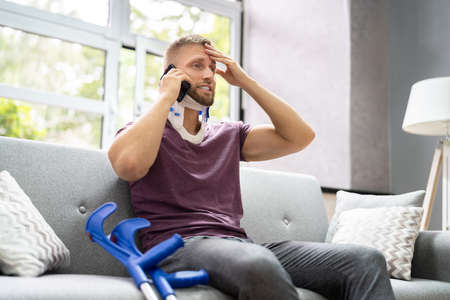 Injured Man With Neck Cast On Phone