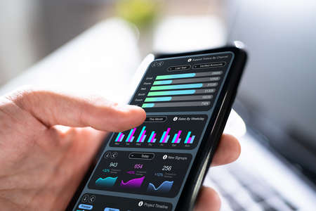 Advisor Looking At Predictive Mobile Analytics Data Reportの写真素材