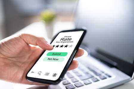 Adult Filling Online Survey Rating Questionnaire On Phone