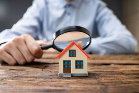 Real Estate House Inspection Before Purchase Using Magnifying Glass
