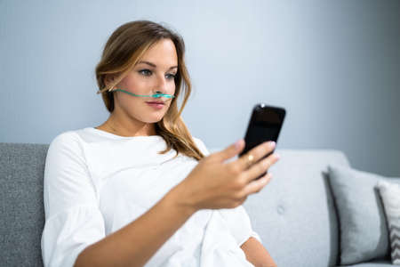 Sick Patient With Nasal Cannula. Ill Woman With Respiratory Diseaseの写真素材