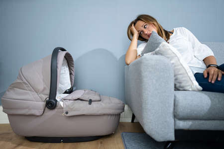 Depressed Unhappy Woman With Newborn. Frustrated Mum