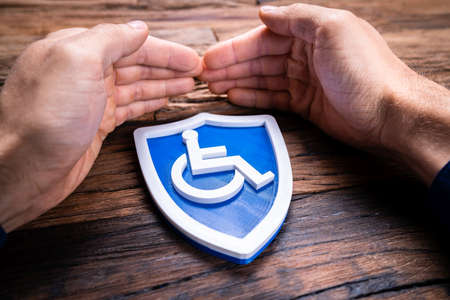 Hands Protecting Disabled Worker Handicap Shield Iconの写真素材