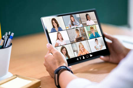 Teacher Hosting Online Class Using Video Conference On Tabletの写真素材