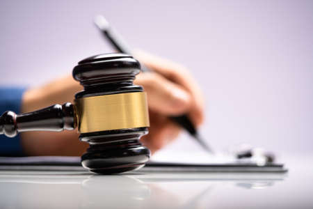 Judge Writing Criminal Order In Courtroom. Court Decision