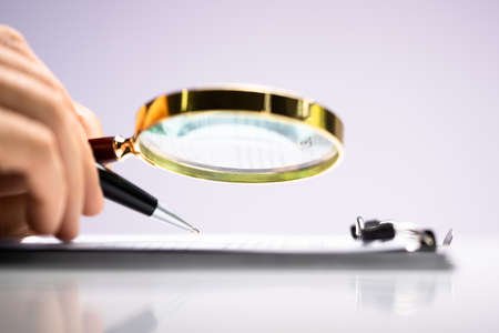 Lawyer Examining With Magnifier Glass. Business Tax Fraud Investigationの写真素材