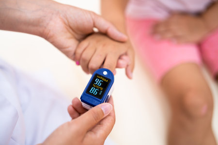 Doctor Checking Child Blood Pulse Using Oximeterの写真素材