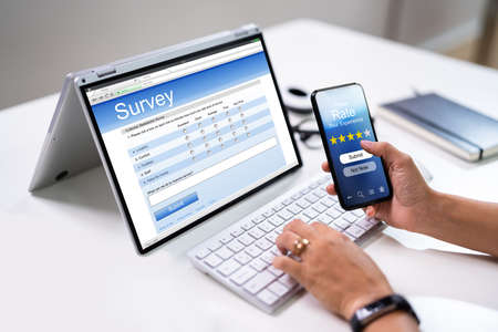 Businesswoman Hand Filling Online Survey On Mobile Phoneの写真素材