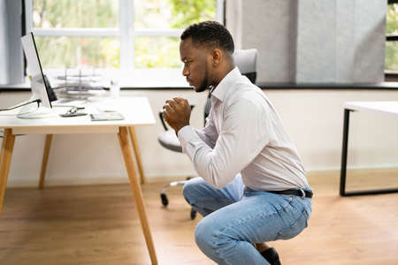 Doing Exercise In Office. Sit Up At Desk