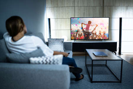 Woman Watching TV Movie. Enjoying Cinema And Televisionの写真素材