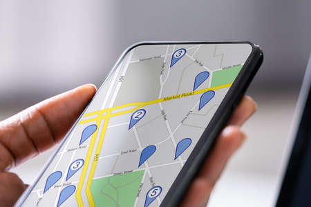 Hand Using GPS Navigation Map On Mobile Phoneの写真素材