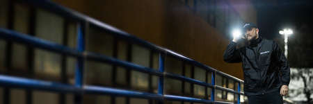 Security Guard Man At Night. Building Alley Patrolの写真素材