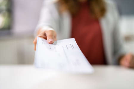 Stimulus Check And PPP Loan Payment Cheque In Handの写真素材