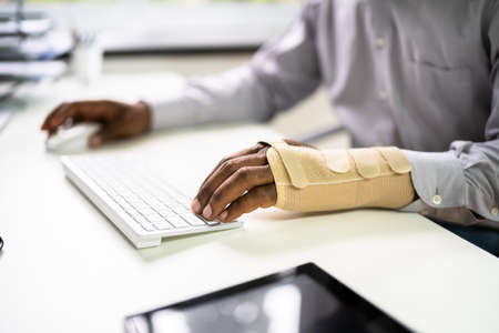 Broken Arm Office Accident. Worker Compensation And Social Coverageの写真素材