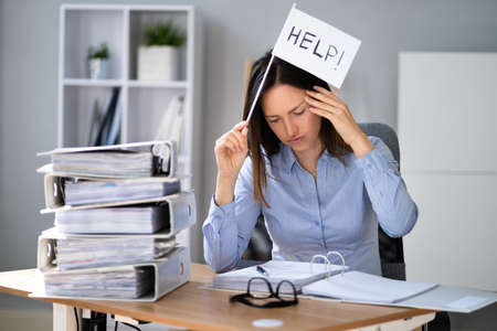 Document Folder Pile. Frustrated Woman Overloaded With Bookkeeping Papersの写真素材
