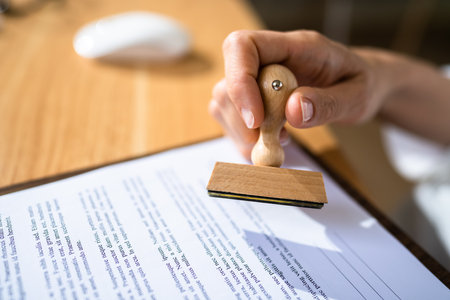 Notary Rubber Stamp In Hand. Official Paper Approvedの写真素材