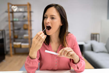 DNA Mouth Saliva Test Swab. Woman Doing Check