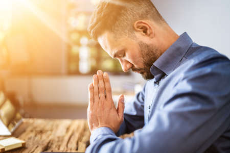 Praying Man. Christian Prayer Seeking God In Living Roomの写真素材