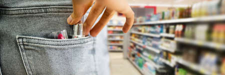 Woman Stealing Lipstick In Retail Store. Shoplifting Theft Crime