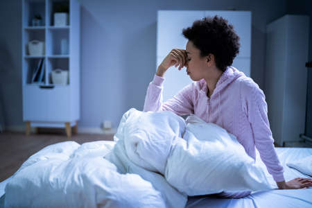Awake African American Woman In Bed With Insomnia. Sleep Nightmareの写真素材