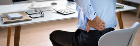 Man With Back Pain. Bad Office Postureの写真素材