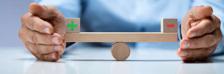 Business Choice And Equilibrium Comparison Concept. Plus Minus Symbolsの写真素材