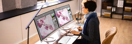 Graphic Designer Artist Working On Multiple Computer Screens