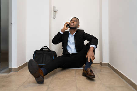 Forgot Key Sitting At Front Door. Calling Locksmith Serviceの写真素材