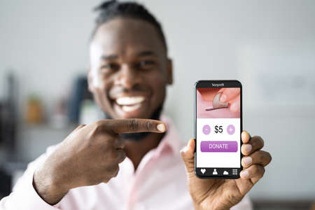 Man Using Online Money Donation Mobile Phone Appの写真素材