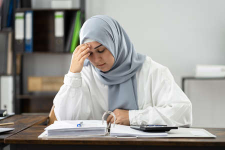 Frustrated Bored Business Woman With Document Workload At Officeの写真素材