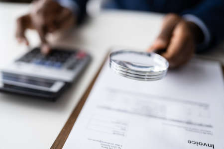 Business Fraud Investigation. Auditor Using Magnifying Glass To Investigateの写真素材