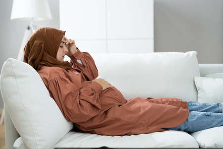 Pregnant Sick Woman With Headache, Discomfort And Painの写真素材