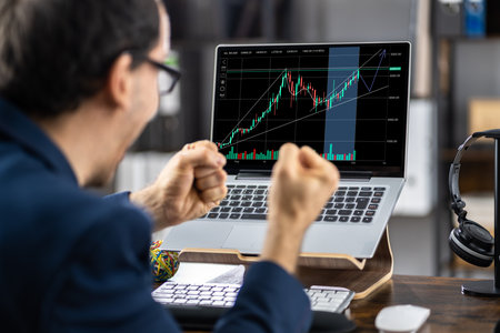Successful Stock Market Trader Working On Laptopの写真素材