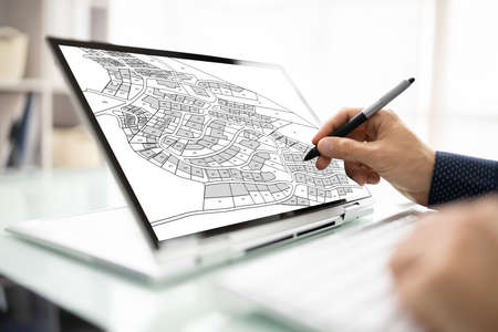 Male Executive Looking At Cadastre Map On Screen