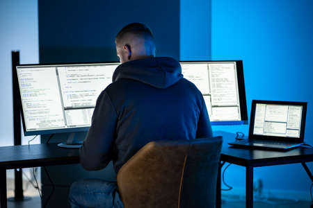 Hacker Using Computer To Write Cyber Security Exploit Software Program