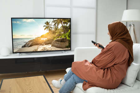 Muslim Woman Watching TV Movie At House Room