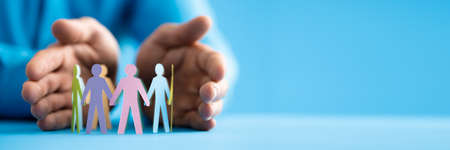Inclusion And Diversity. Hand Protecting Inclusive Equal Pawnsの写真素材