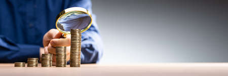 Analyze And Monitor Expenses With Magnifying Glassの写真素材