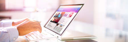 Reading News Website Or Electronic Newspaper On Screenの写真素材