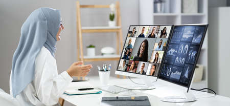 Watching Online Video Conference Meeting In Office