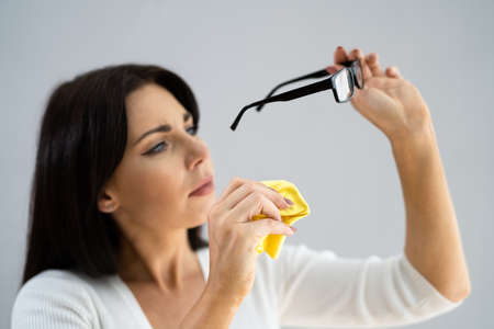Obsessive Compulsive Perfectionist With OCD Disorder Cleaning Glassesの写真素材